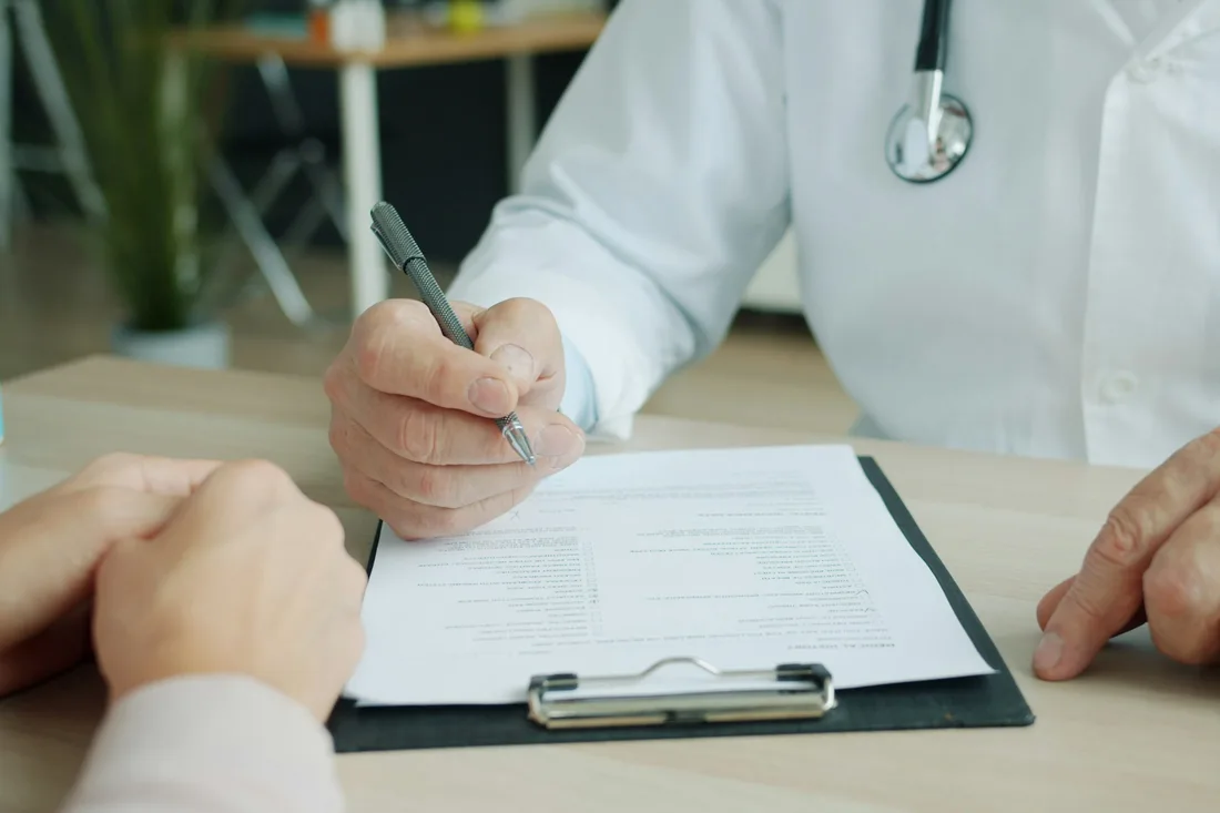 Doctor reviewing a medical intake form with a patient