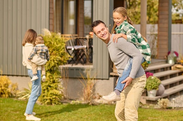 Family outside their home reviewing health coverage options